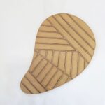 This sand coloured gumleaf design carved ceramic pot trivet protects the bench or table.